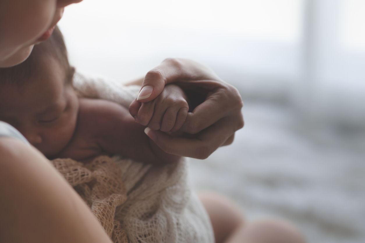 mother cradling newborn baby