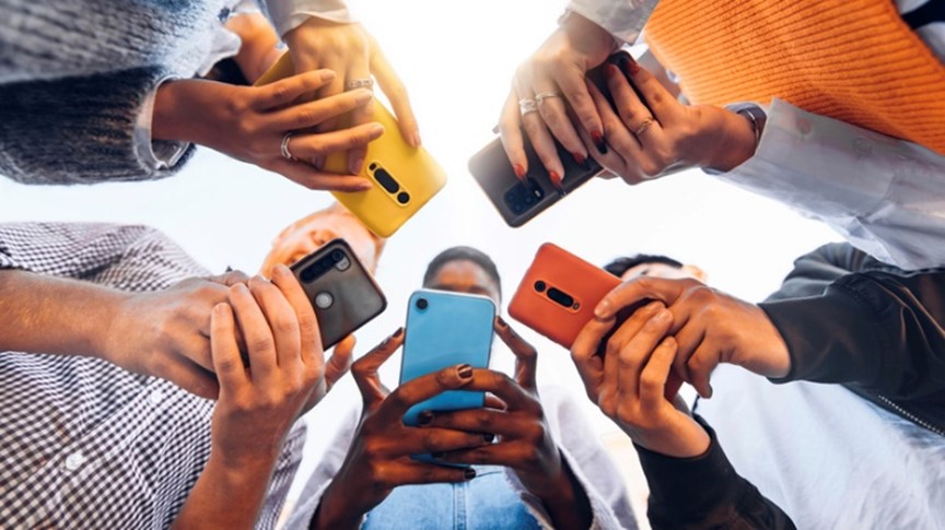 group of people looking down at their cell phones