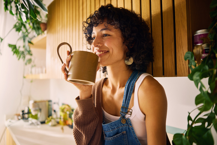 smiling woman with coffee in the morning