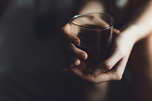 person holding a glass of alcohol