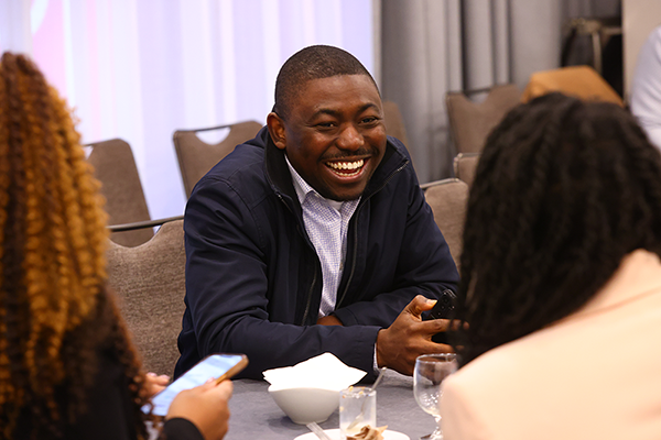 Fellows sitting at table and talking with each other