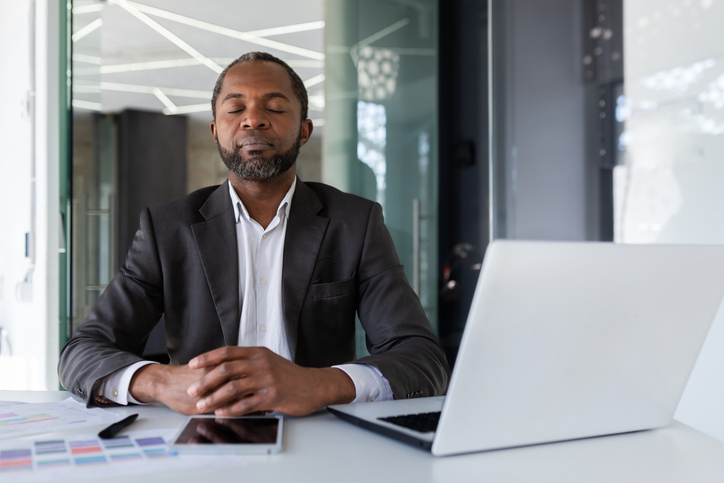 man meditating at desk